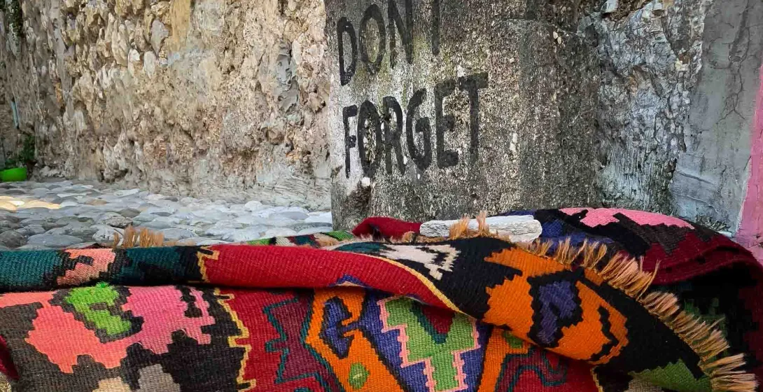 Colorful rug on a cobblestone street in Berat, Albania.