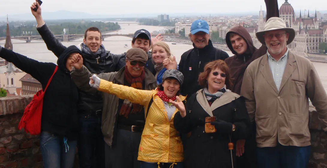 Happy tourists in Budapest enjoying a city view.