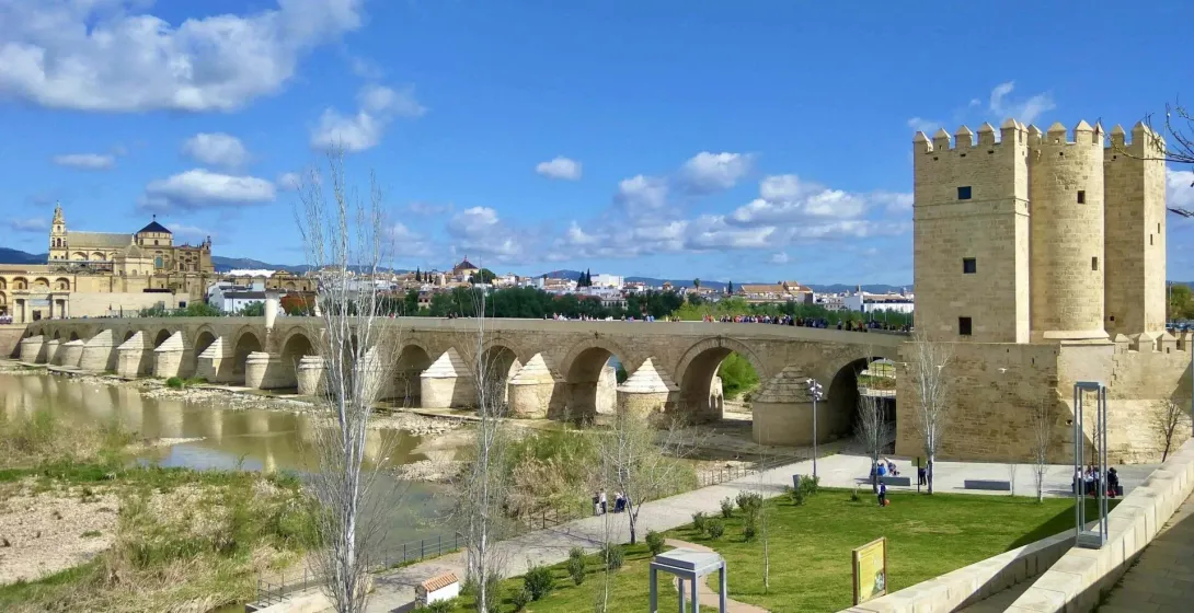 Panoramic view of the Roman Bridge, Guadalquivir River, Torre de la Calahorra, and Mezquita-Cathedral in Cordoba.