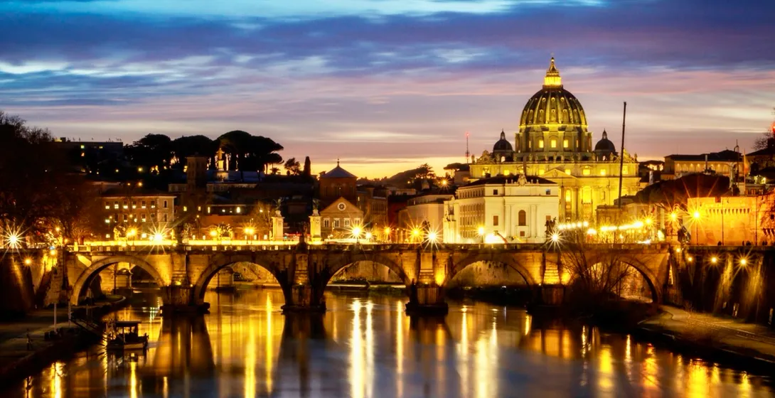 Stunning sunset view of St. Peter's Basilica and Ponte Sant'Angelo in Rome.