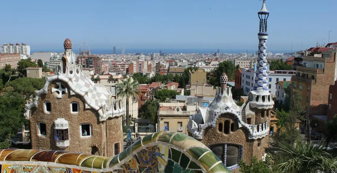 Panoramic view of Barcelona from Park Güell, showcasing Gaudí's iconic mosaic structures.