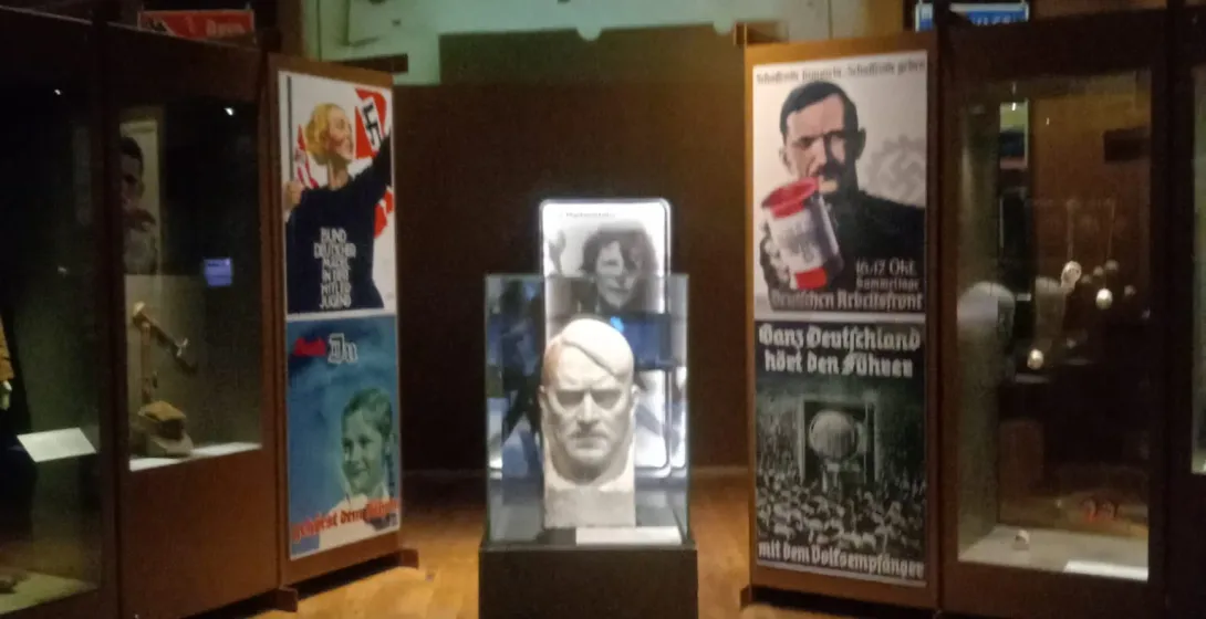 Museum exhibit in Gdansk showcasing Nazi propaganda posters and artifacts.