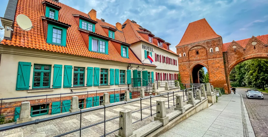 Charming hotel near a historic brick gate.