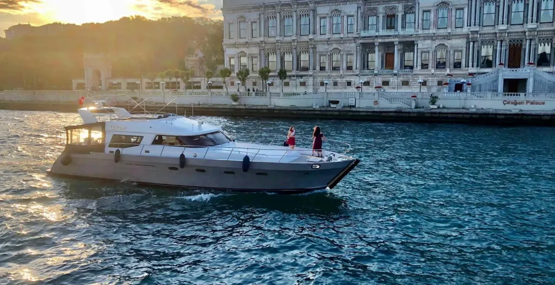 Private yacht tour in Istanbul, passing by the Çırağan Palace at sunset.