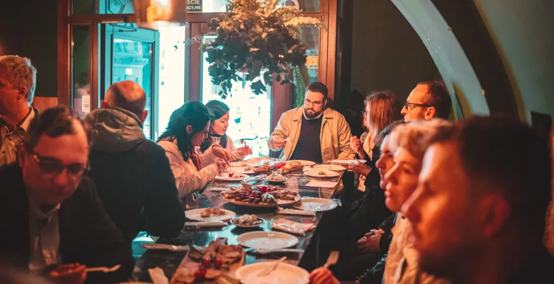 A group of tourists enjoying a food tour in Krakow, Poland.