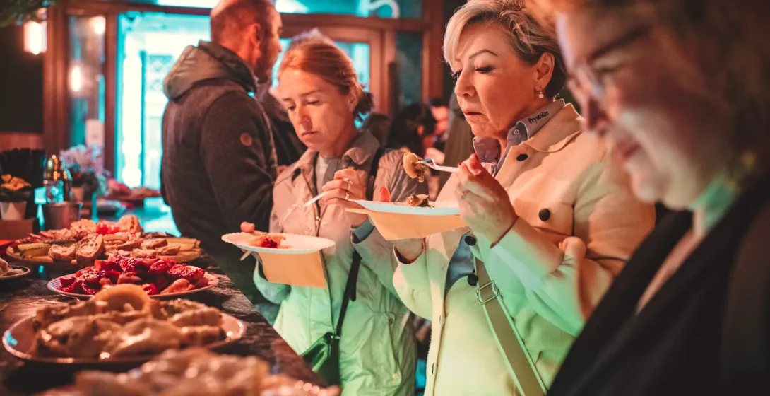 Tourists enjoying a delicious food tour in Krakow, Poland.