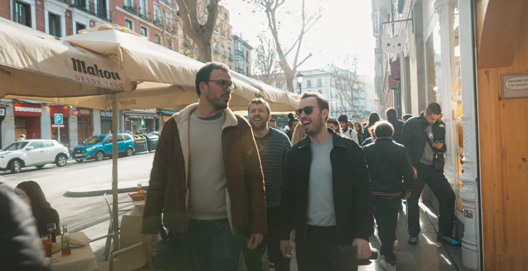 Tourists enjoying a walking tour in sunny Madrid.