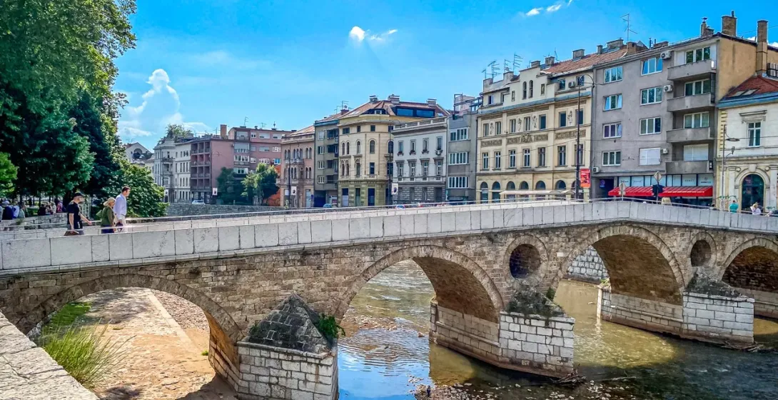 Tourists enjoying a city tour on the historic Latin Bridge in Sarajevo.