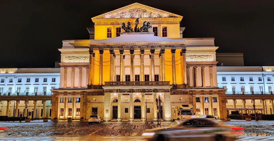 Warsaw Grand Theatre at night, illuminated beautifully. Free Walkative Tour.