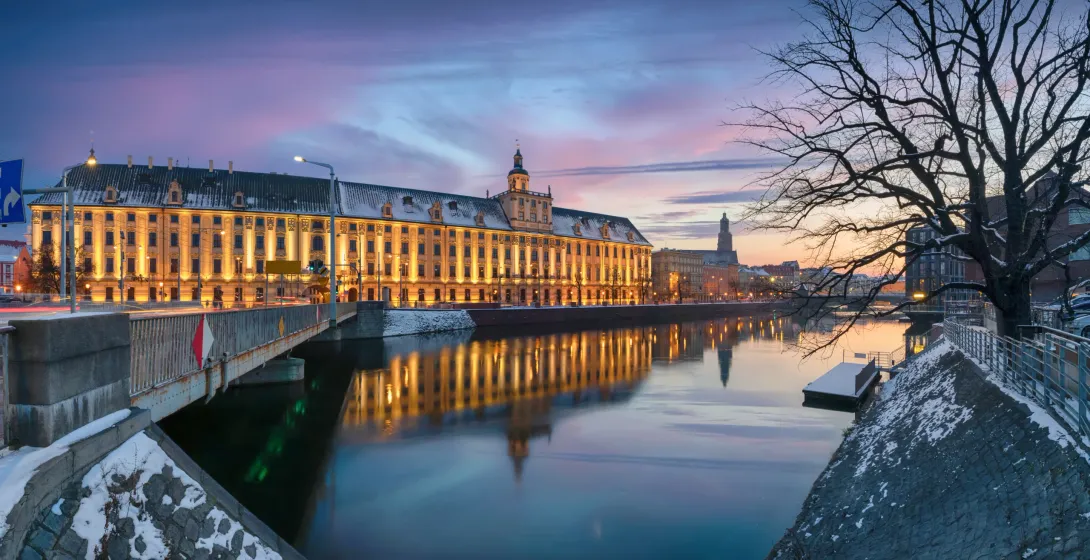 Universität Wrocław in der Abenddämmerung, reflektiert in der Oder.