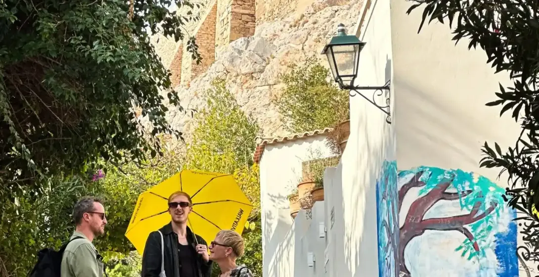Tourists exploring Athens, Greece, near the Acropolis.