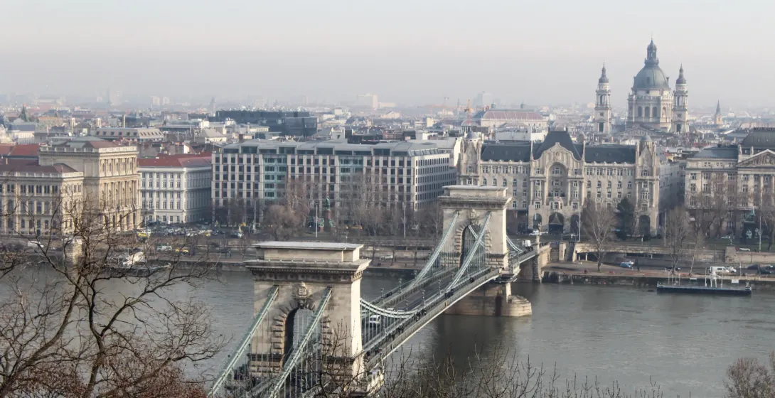 View over the Szechenyi Chain Bridge and the Danube River towards the Pest side of Budapest on a hazy day.