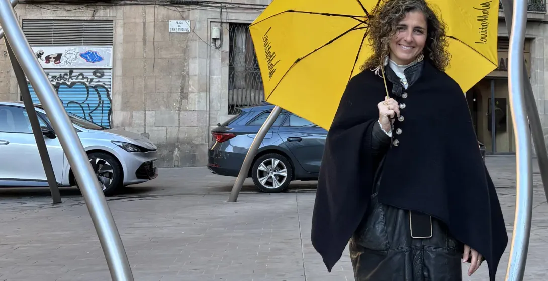 Walkative tour guide holding a yellow umbrella at Plaça de Sant Miquel in Barcelona.