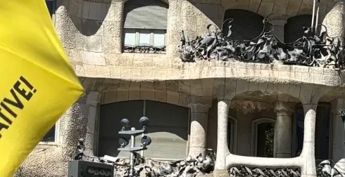 La Pedrera (Casa Milà) by Gaudí in Barcelona. Features wavy stone facade, distinctive balconies, sculptures, and clear sky.