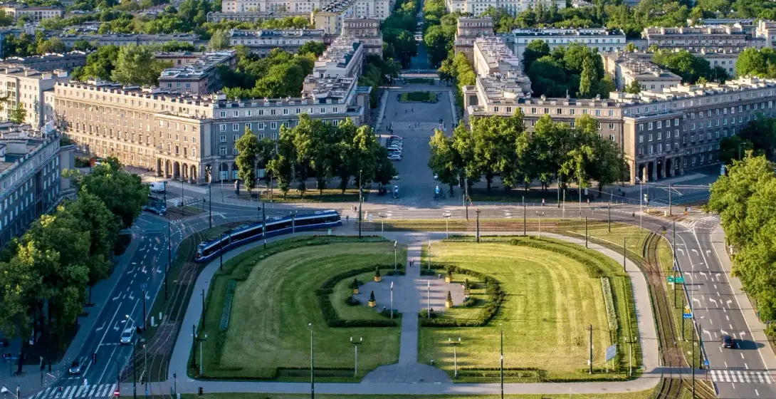 Aerial view of Plac Centralny in Nowa Huta, Krakow, showing its symmetrical layout, buildings, and green spaces on a sunny...