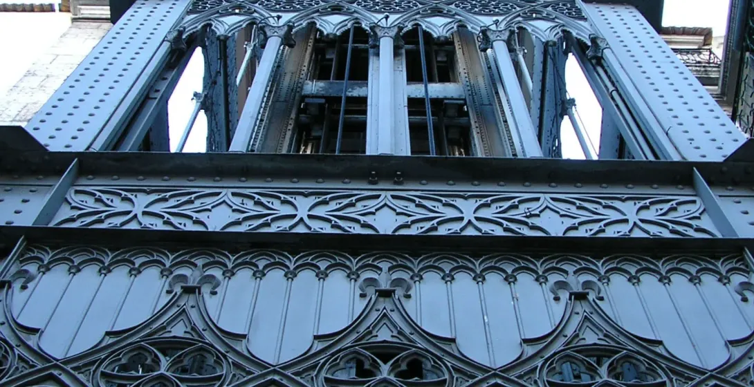 Looking up at the ornate neo-Gothic ironwork of the Santa Justa Lift in Lisbon.