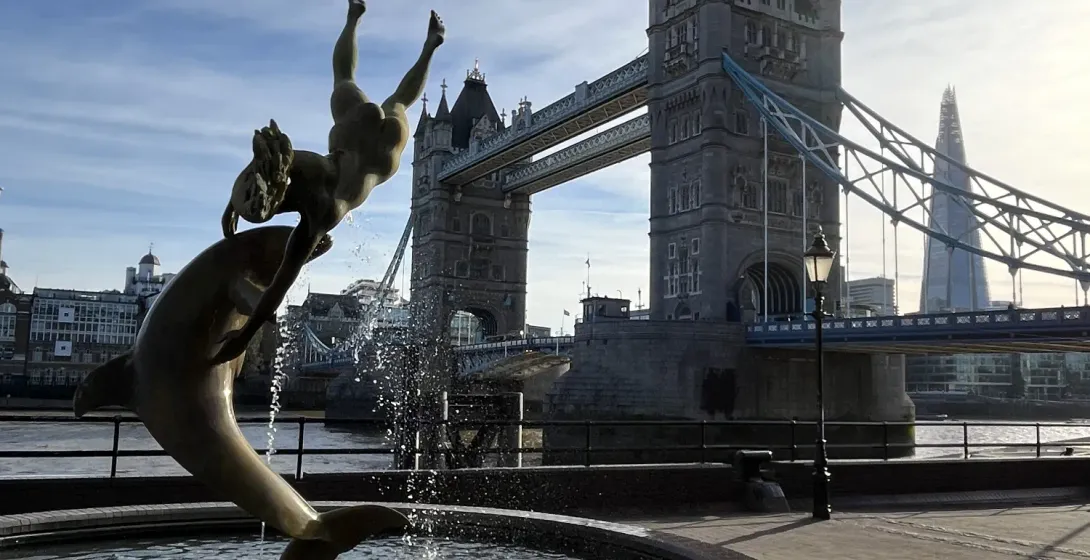The Girl with a Dolphin fountain on the bank of the Thames, with Tower Bridge and the Shard in the background.