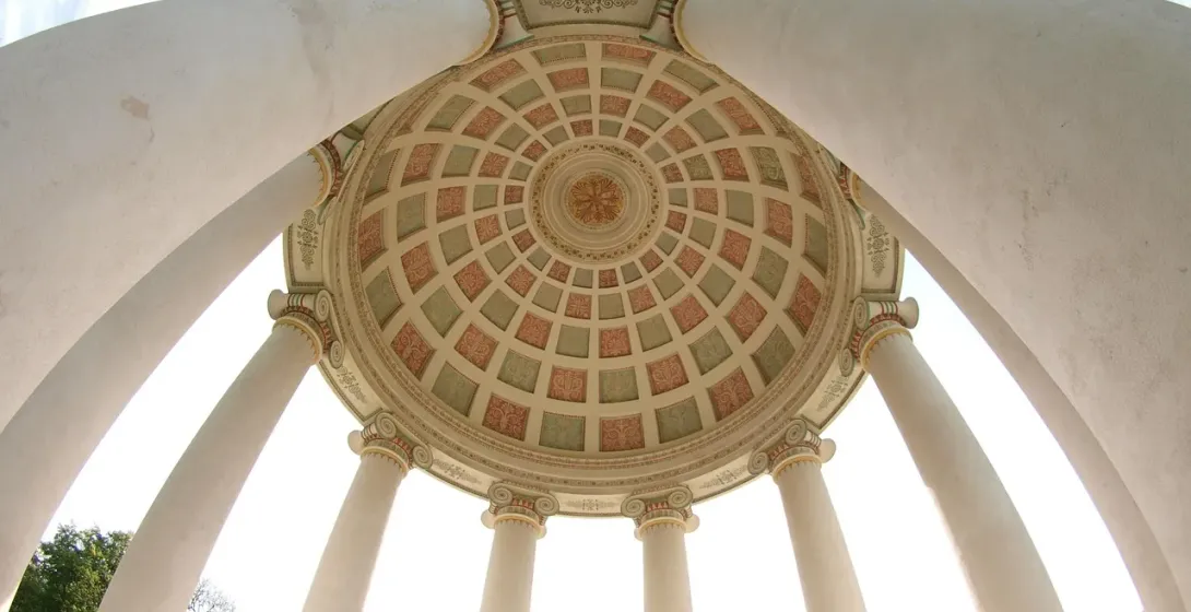 Interior view of the Monopteros rotunda in Munich's Englischer Garten, showing its classical dome ceiling with ornate patt...
