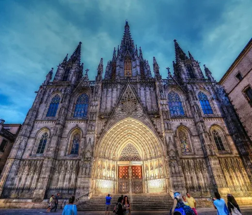 Barcelona Cathedral at dusk, tourists admiring the Gothic architecture.