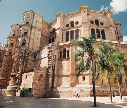 Tourists explore the magnificent Murcia Cathedral in Spain.