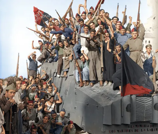 Spanish Republican soldiers celebrate atop an armored car during the Spanish Civil War.