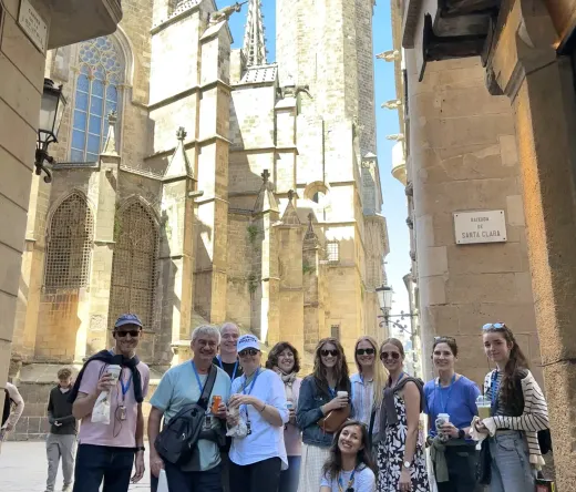 Barcelona Cathedral at dusk, tourists admiring the Gothic architecture.