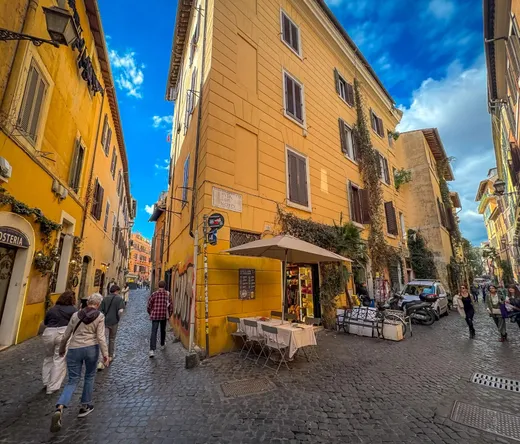 Tourists exploring the charming cobblestone streets of Trastevere, Rome.