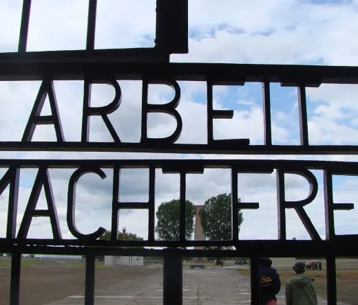 Touristen besuchen das Tor des Konzentrationslagers Sachsenhausen in Berlin, Deutschland.