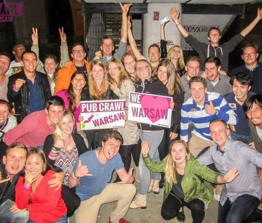 A large group of happy tourists on a pub crawl in Warsaw, Poland.