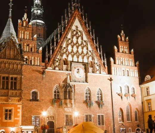Night view of Wrocław's Old Town Hall, a stunning example of Gothic architecture.