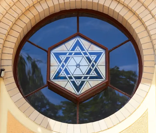 Close-up of a beautiful stained-glass Star of David in a circular window of a building in Wrocław, Poland.
