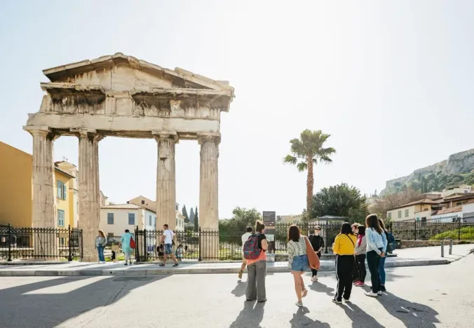Tour group exploring the ancient Temple of Hephaestus in Athens, Greece.