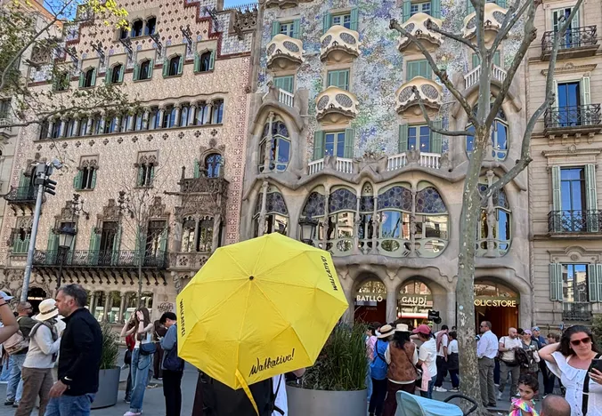Tourists exploring the vibrant mosaic architecture of Park Güell in Barcelona.