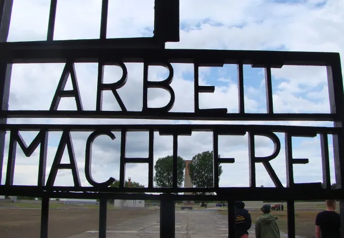 Tourists visiting the Sachsenhausen Concentration Camp gate in Berlin, Germany.