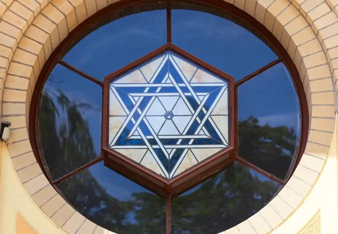 Close-up of a beautiful stained-glass Star of David in a circular window of a building in Wrocław, Poland.
