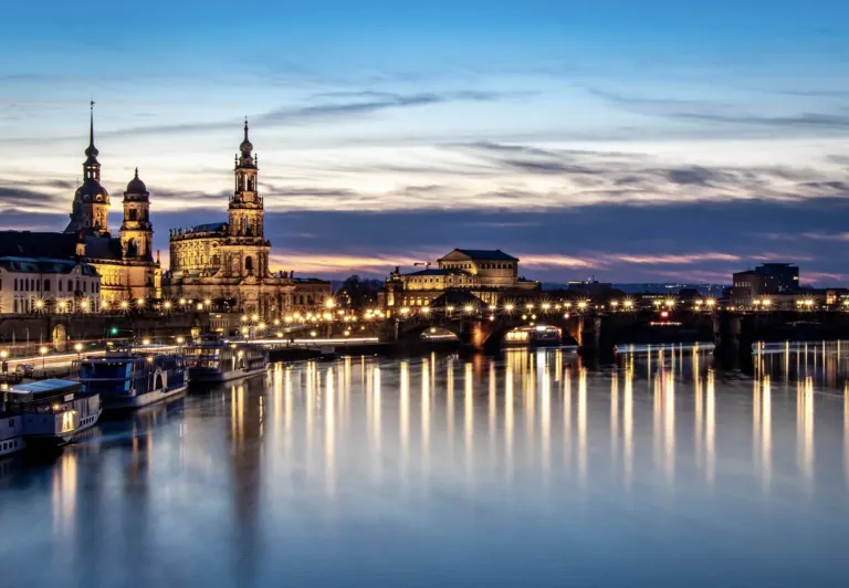 Dresden Old Town at night: Frauenkirche and Zwinger Palace illuminated.