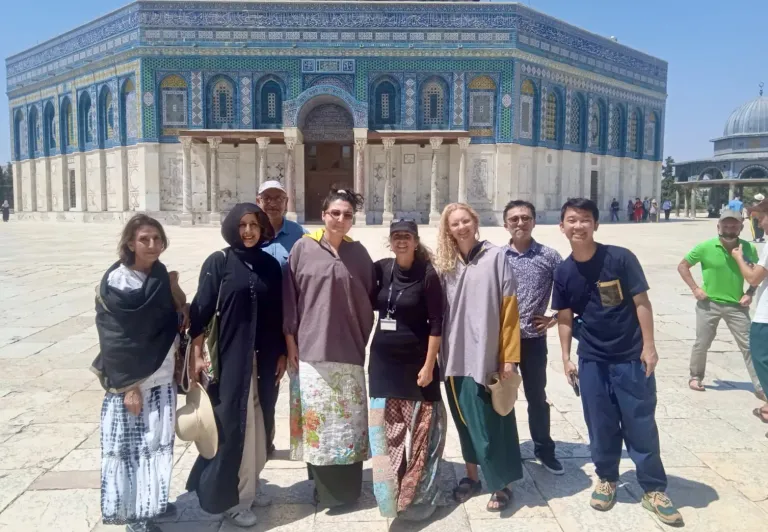 Fröhliche Touristen auf einer geführten Tour vor dem Felsendom in Jerusalem.