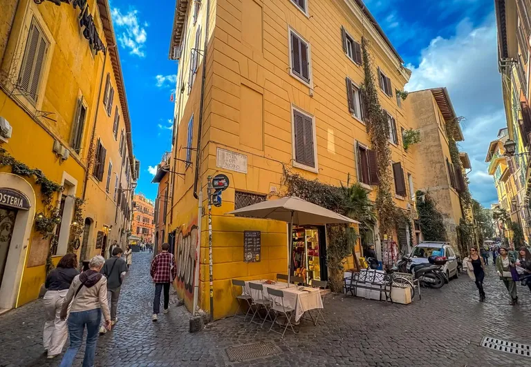 Tourists exploring the charming cobblestone streets of Trastevere, Rome.