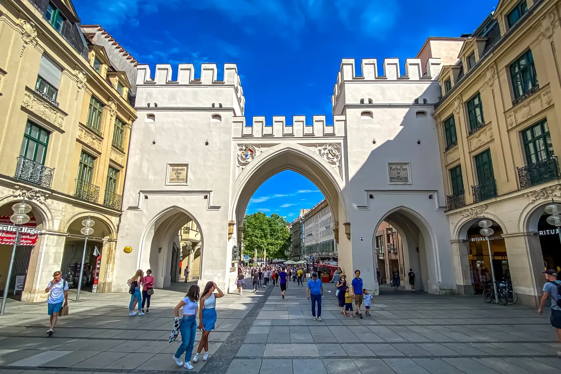 Tourists exploring the historic Karlstor in Munich, Germany.