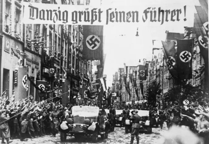 Historical motorcade in Gdańsk with banners.