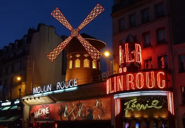 The dazzling Moulin Rouge in Paris at night.