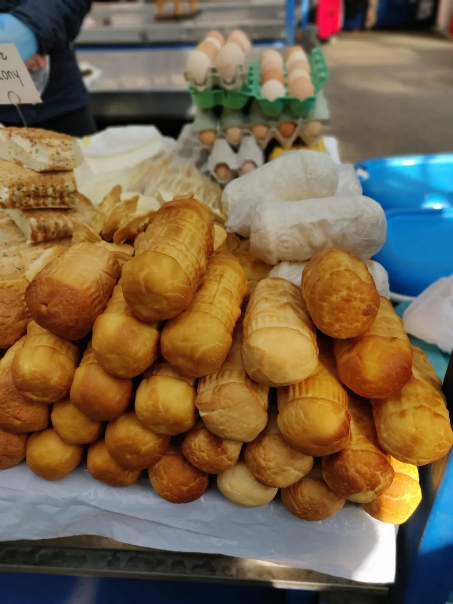Golden-brown oscypek cheese displayed at a Polish market.