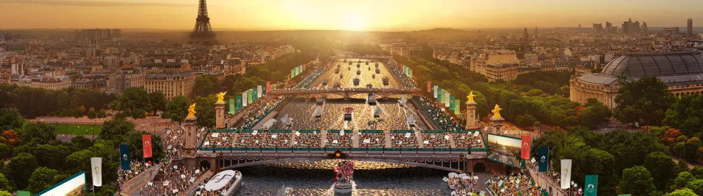 Aerial view of Paris at sunset with the Seine River, boats, Pont Alexandre III, and spectator stands for an Olympic event. Ei