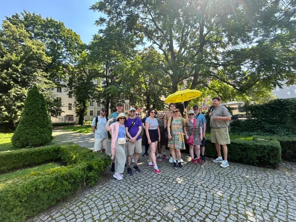Tour group under the yellow umbrella in the Chopin Park in Poznań.