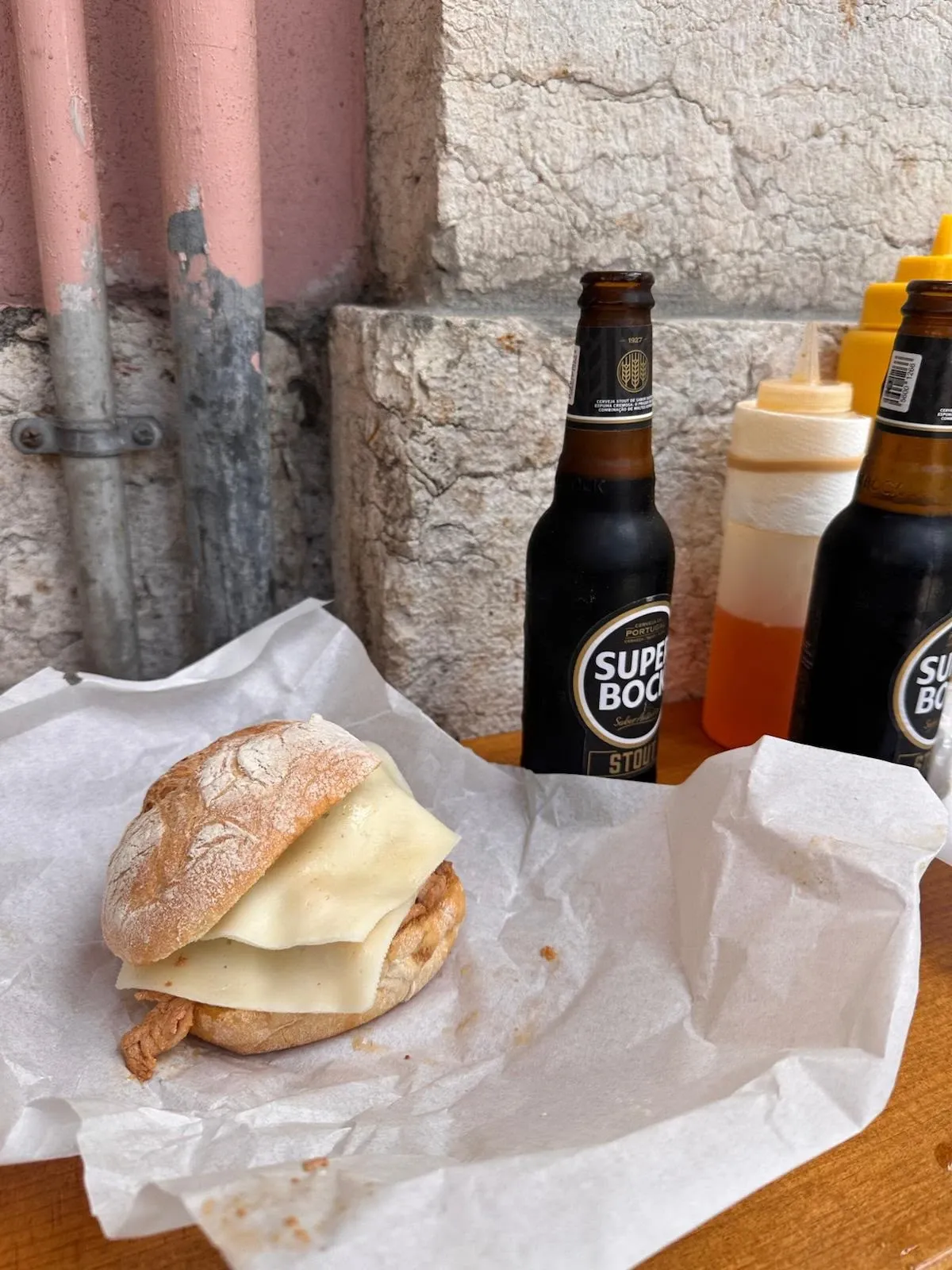 A Portuguese pork bifana sandwich with cheese from Bifanas do Afonso.