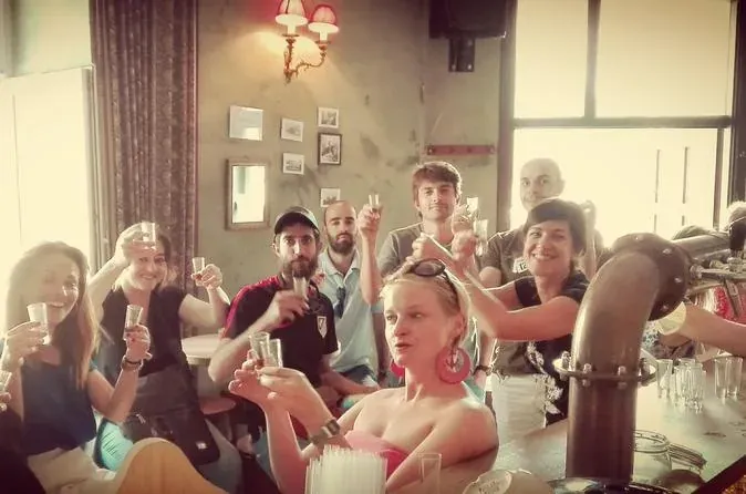 Tour group toasting with glasses.