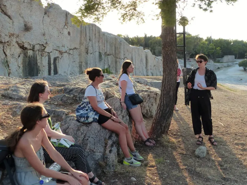 A guided tour group explores ancient ruins in Athens, Greece.