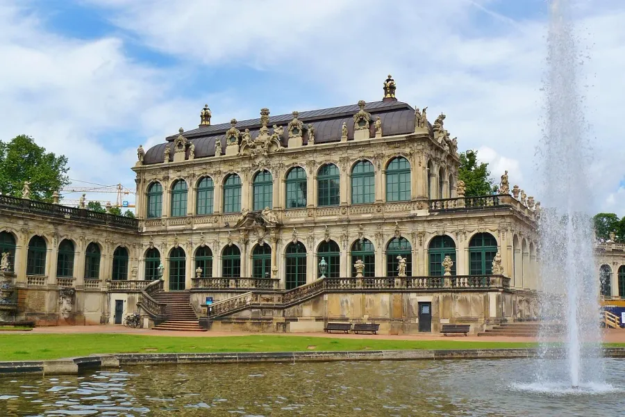 Palacio Zwinger en Dresde, Alemania: un impresionante palacio barroco con una piscina reflectante y una fuente.