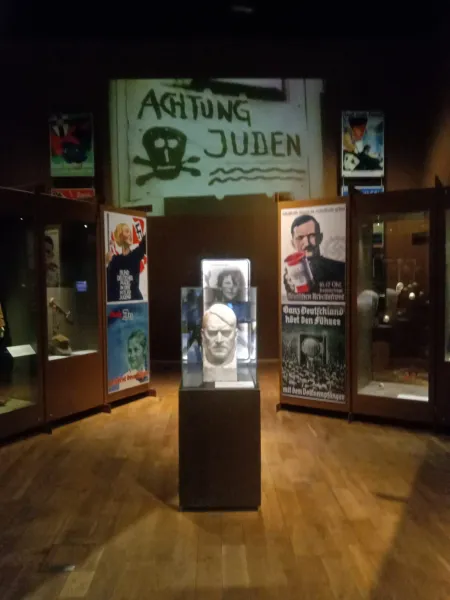 Museum exhibit in Gdansk showcasing Nazi propaganda posters and artifacts.