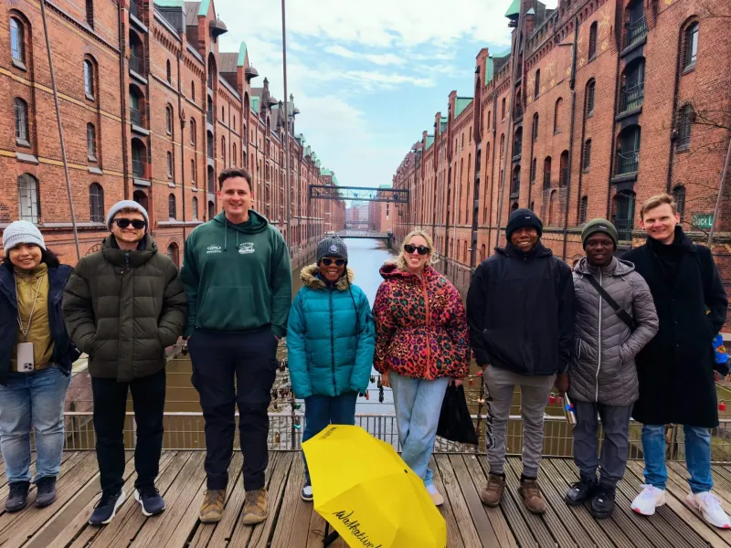 Turistas felices en una visita guiada a la Speicherstadt de Hamburgo.